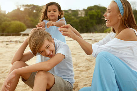 Summer. Family Picnic On Beach. Portrait Of Young Woman With Son Enjoying Lunch At Tropical Ocean. Mother And Handsome Boy On Vacation Near Sea. Organic Fruit And Natural Vitamins.の写真素材