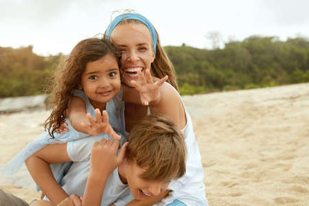 Summer. Family Picnic On Beach. Portrait Of Young Woman With Son Enjoying Lunch At Tropical Ocean. Mother And Handsome Boy On Vacation Near Sea. Organic Fruit And Natural Vitamins.の写真素材