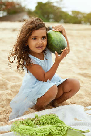 Summer. Family Picnic On Beach. Portrait Of Young Woman With Son Enjoying Lunch At Tropical Ocean. Mother And Handsome Boy On Vacation Near Sea. Organic Fruit And Natural Vitamins.の写真素材