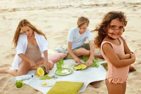 Summer. Family Picnic On Beach. Portrait Of Young Woman With Son Enjoying Lunch At Tropical Ocean. Mother And Handsome Boy On Vacation Near Sea. Organic Fruit And Natural Vitamins.の写真素材