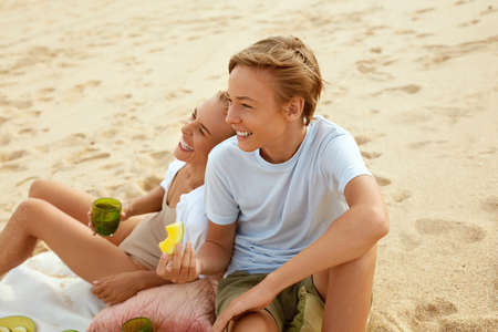 Summer. Family Picnic On Beach. Portrait Of Young Woman With Son Enjoying Lunch At Tropical Ocean. Mother And Handsome Boy On Vacation Near Sea. Organic Fruit And Natural Vitamins.の写真素材