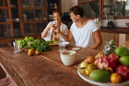 Healthy Food. Couple Cooking Vegetable Salad And Drinking Water At Kitchen In Tropical Villa. Woman And Man Preparing Fresh Organic Food For Lunch. Natural Vitamins For Nutrition On Summer Vacation.の写真素材