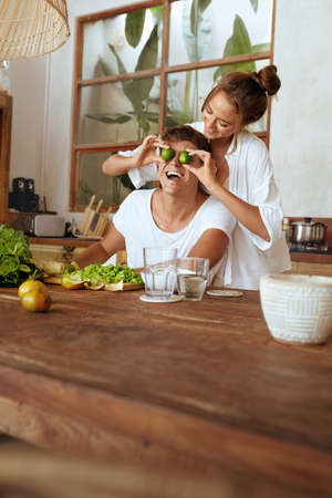 Lifestyle. Couple At Kitchen Cooking Healthy Vegetarian Food And Having Fun. Handsome Man And Beautiful Woman Enjoying Romantic Weekend Or Honeymoon At Tropical Villa.の写真素材