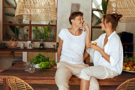 Healthy Food. Romantic Couple At Kitchen In Tropical Villa. Woman And Man Having Fun While Cooking Organic Food For Lunch. Natural Vitamins For Nutrition On Summer Vacation.の写真素材