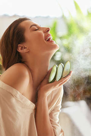 Beauty. Woman With Aloe Vera. Portrait Of Happy Model With Naked Shoulder And Natural Makeup Holding Slices Of Fresh Leaf. Organic Cosmetic For Glowing And Hydrated Skin.の写真素材