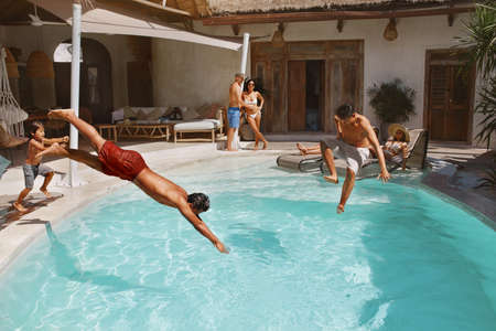 Summer Activity. Pool Entertainment On Family Vacation At Tropical Resort. Parents With Son, Daughters And Their Boyfriends Having Fun On Weekend. Group Of Happy People Enjoying Leisure Together.の写真素材