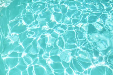 Water In Pool Texture. Turquoise Pure Aqua Surface With Ripples And Glares Pattern. Fresh Liquid With Sunlight Reflection In Summer.の写真素材