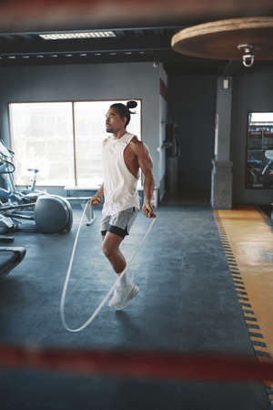 Portrait Of Man On Boxing Ring. Sexy Asian Sportsman With Strong, Healthy, Muscular Body At Fitness Center. Boxer With Elastic Tapes On Wrists Having Break After Training At Gym.の写真素材