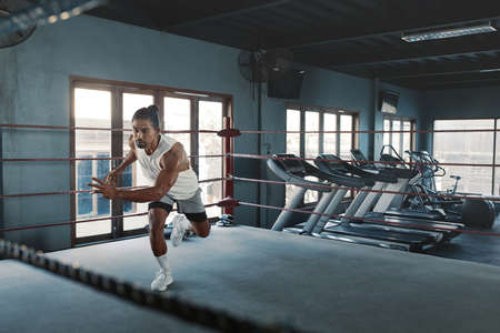 Portrait Of Man On Boxing Ring. Sexy Asian Sportsman With Strong, Healthy, Muscular Body At Fitness Center. Boxer With Elastic Tapes On Wrists Having Break After Training At Gym.の写真素材
