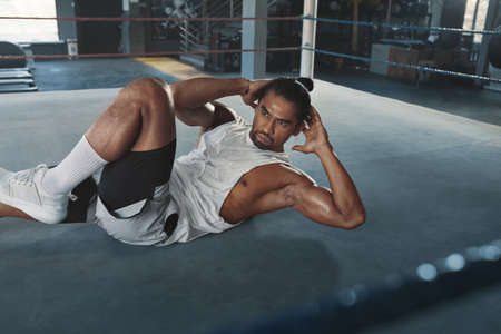 Abs Workout. Man At Gym Doing Abdominal Exercise For Strong, Healthy, Muscular Body. Portrait Of Sexy Asian Sportsman Training On Boxing Ring At Fitness Center. Bodybuilding As Lifestyle.の写真素材
