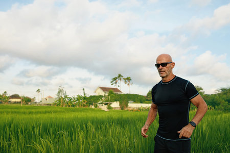 Caucasian Man Running On Rice Field In Morning. Sporty Man In Sportswear On Jogging Workout Among...