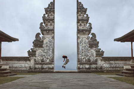 Beautiful Girl Full-Length Portrait Near Gates Of Heaven In Pura Lempuyang Temple In Bali, Indonesia.の写真素材
