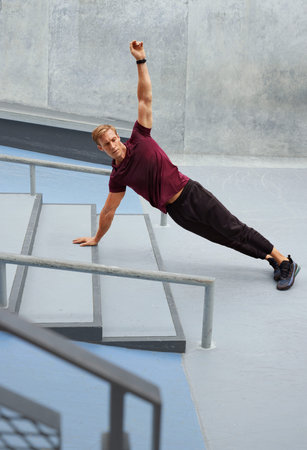 Young Man Doing Plank Near Concrete Steps Outdoors. Handsome Caucasian Sportsman With Strong...