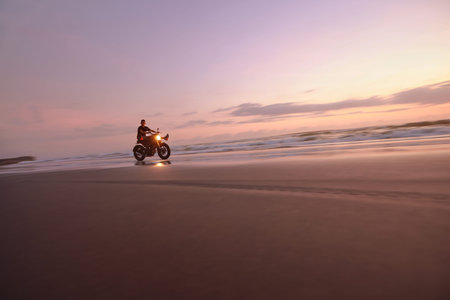 Man And Motorcycle On Ocean Beach At Beautiful Tropical Sunset. Biker Silhouette On Motorbike On Sandy Coast Near Sea In Bali, Indonesia.の写真素材