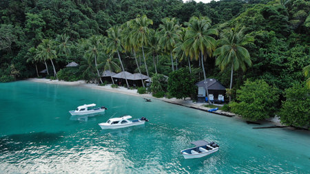 Aerial View Of Man Lying On Sandy Beach Near Turquoise Sea In Kri Island, Raja Ampat. Guy Resting On...