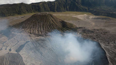 Close view of Mount Bromo volcano crater in clouds of smoke. Mount Bromo is active Indonesian volcano in East Java.の写真素材