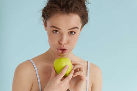 Woman with green apple. Woman holding green apple and smilingの写真素材