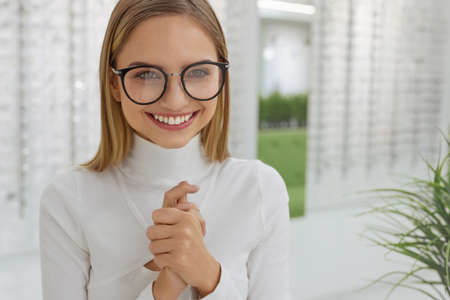 Eyeglasses Store. Woman Posing at Glasses For Eyesight Correctionの写真素材