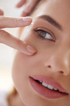 Contact Lens For Vision. Female Face With Contact Lensの写真素材