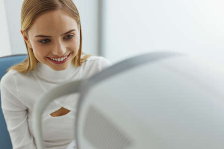 Eyesight Exam. Woman Checking Eye Vision On Optometry Equipmentの写真素材
