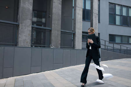 Busy Confident Business Lady Holding Laptop and Hurry Up at Workの写真素材
