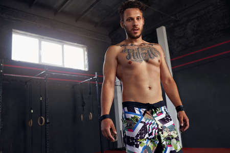 Handsome Half Naked Muscular Man Posing In Gym. Confident Fitness Trainerの写真素材