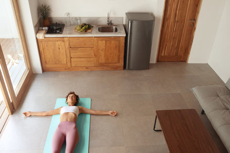 Woman In Yoga Position. Female In Fashion Sportswear Practicing At Homeの写真素材
