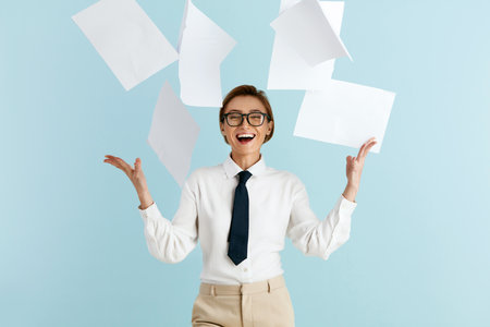Happy Businesswoman Rejoicing Isolated. Woman With Pile of Papers Flying on Airの写真素材