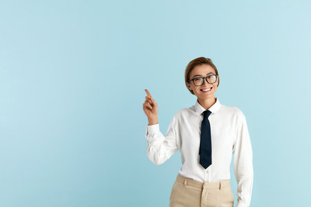 Smiling Businesswoman Pointing Hand. Positive Lady Pointing Awayの写真素材
