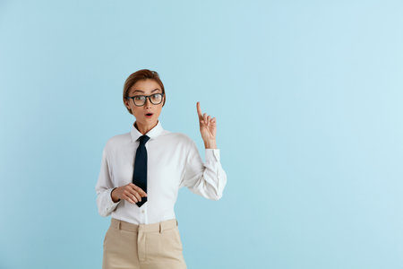 Smiling Businesswoman Pointing Hand. Positive Lady Pointing Awayの写真素材