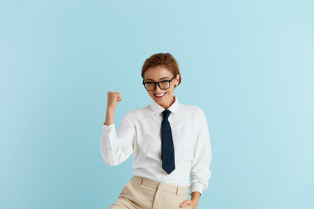 Excited Businesswoman Rejoicing Isolated. Girl Standing with Raised Handsの写真素材