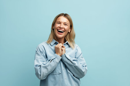 Surprised Woman Rejoicing Success. Portrait of Delighted Blonde Girl Celebrating