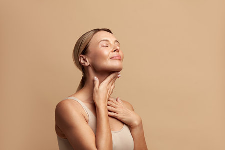 Smiling Woman Touching Neck. Attractive Woman Touching her Skin and Smilingの写真素材