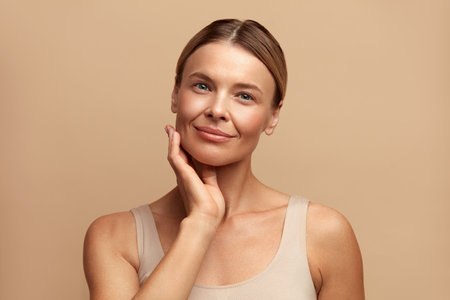 Smiling Woman Touching Face. Attractive Woman Touching her Skin and Smilingの写真素材