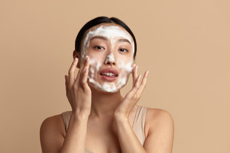 Face Skin Care. Asian Woman Cleaning Facial Skin with Foam Soapの写真素材