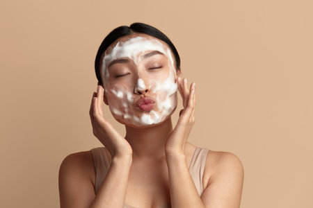 Face Skin Care. Funny Asian Woman Cleaning Facial Skin with Foam Soapの写真素材