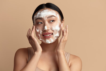 Face Skin Care. Cute Asian Woman Cleaning Facial Skin with Foam Soapの写真素材