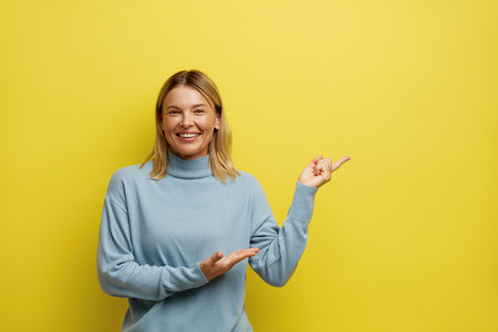 Happy Woman Pointing Aside. Amused Young Girl Points Fingers Awayの写真素材