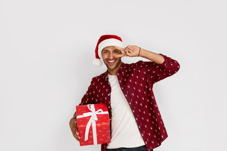 Happy Man Holding Present. Excited Multiracial Guy Holding Wrapped Present Boxの写真素材