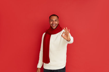 Smiling Man Showing Ok Gesture. Satisfied Multiracial Guy Making Ok Symbolの写真素材