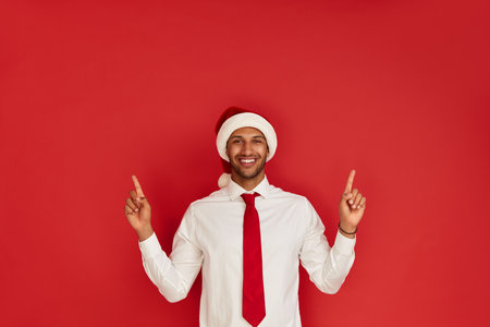Smiling Man Pointing Hand. Positive Guy Pointing Away Paying Your Attentionの写真素材