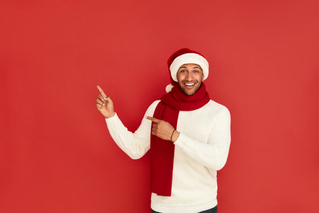 Smiling Man Pointing Hand. Positive Multiracial Guy Pointing Awayの写真素材