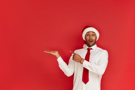 Shocked Man Pointing Aside. Astonished Guy Pointing at Copy Spaceの写真素材