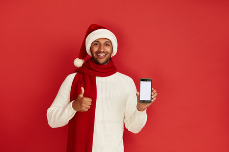 Happy Man Thumbs Up. Pleased Multiracial Man Smiling Showing Smartphoneの写真素材