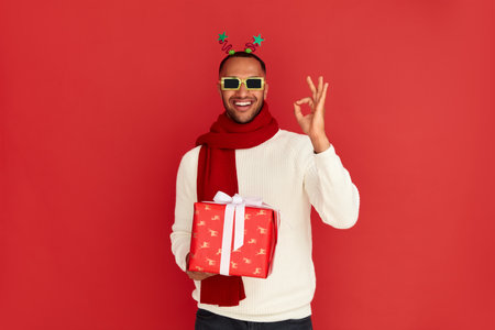 Smiling Man Showing Ok Gesture. Multiracial Guy Satisfied with Presentの写真素材