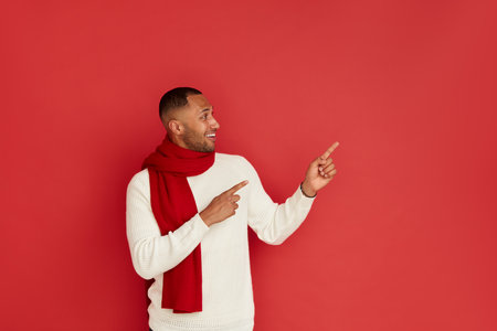 Smiling Man Pointing Hand. Positive Multiracial Guy Pointing Awayの写真素材