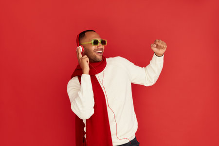 Winter Man Listening Music. Positive Multiracial Man Listening Song Headphonesの写真素材