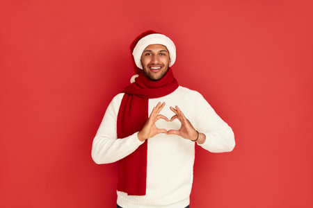 Smiling Man Showing Heart Shape Gesture. Positive Man Showing Romantic Gestureの写真素材