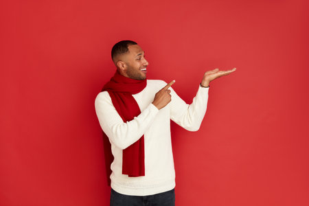 Smiling Man Pointing Hand. Positive Multiracial Guy Pointing Awayの写真素材
