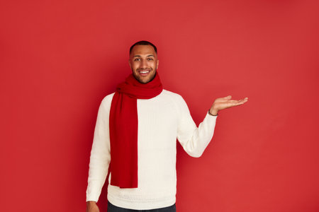 Smiling Man Pointing Hand. Positive Multiracial Guy Pointing Awayの写真素材